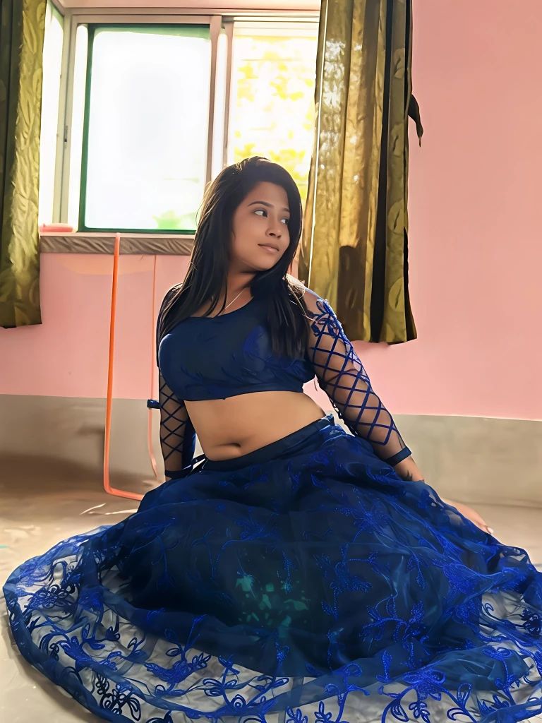 Chubby escort in Kolkata seated in a traditional dark blue outfit with mesh sleeves