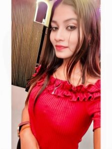 Kiara escort college girl side pose red outfit stylish look